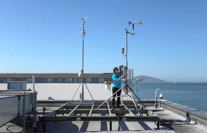 Alexis Shusterman performs maintenance on a rooftop carbon dioxide sensor at San Francisco's Exploratorium. Credit: Michael Wan